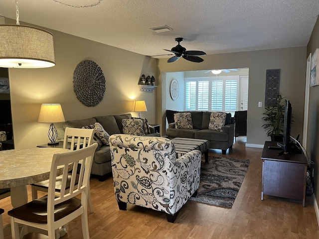 13852 Via Flora Unit A, Delray Beach, FL 33484 - living room with ceiling fan, wood finished floors, and a textured ceiling