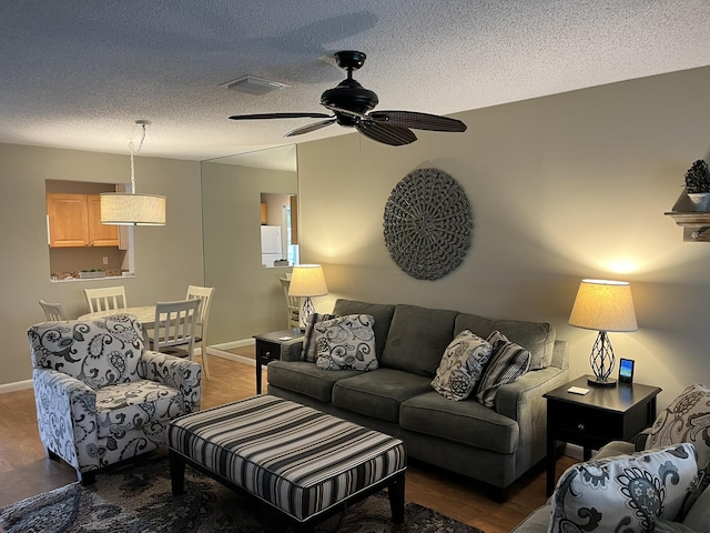 13852 Via Flora Unit A, Delray Beach, FL 33484 - living area with a ceiling fan, a textured ceiling, baseboards, and wood finished floors