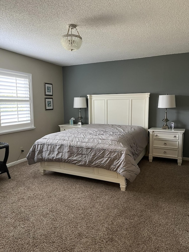 13852 Via Flora Unit A, Delray Beach, FL 33484 - bedroom featuring dark colored carpet, baseboards, and a textured ceiling