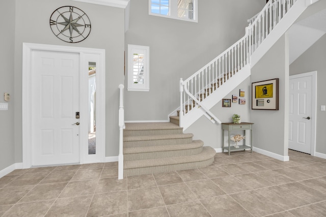 1909 Flower Dr, Palm Beach Gardens, FL 33410 - tiled entrance foyer featuring a towering ceiling and stairway