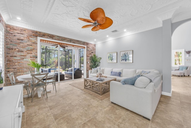 1909 Flower Dr, Palm Beach Gardens, FL 33410 - living area featuring brick wall, ceiling fan, arched walkways, light tile patterned floors, and recessed lighting