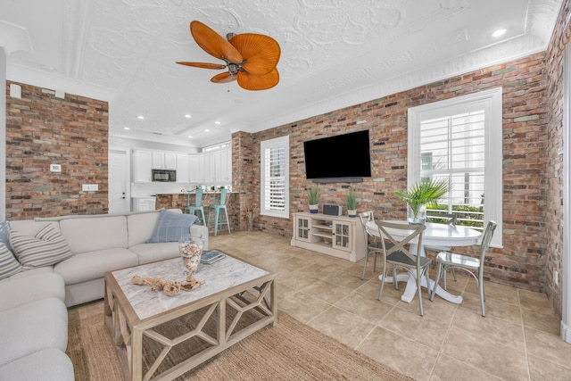 1909 Flower Dr, Palm Beach Gardens, FL 33410 - living room featuring brick wall, light tile patterned floors, and a ceiling fan