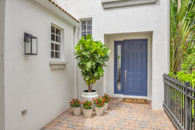 1909 Flower Dr, Palm Beach Gardens, FL 33410 - doorway to property with stucco siding