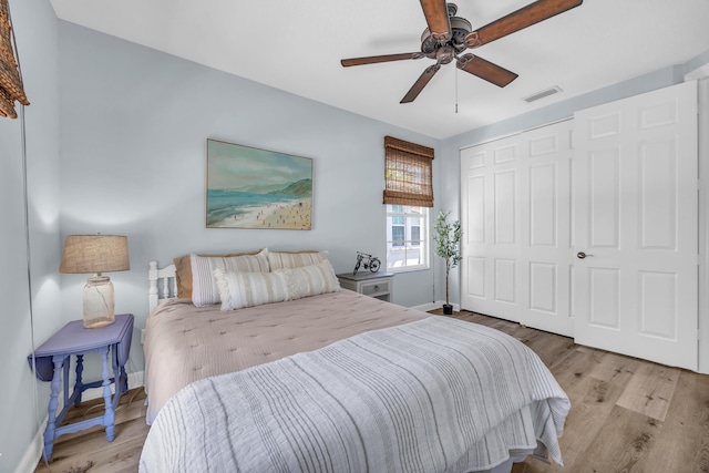 1909 Flower Dr, Palm Beach Gardens, FL 33410 - bedroom featuring a closet, wood finished floors, and ceiling fan