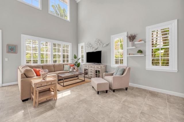 1909 Flower Dr, Palm Beach Gardens, FL 33410 - living room featuring a towering ceiling and light tile patterned flooring