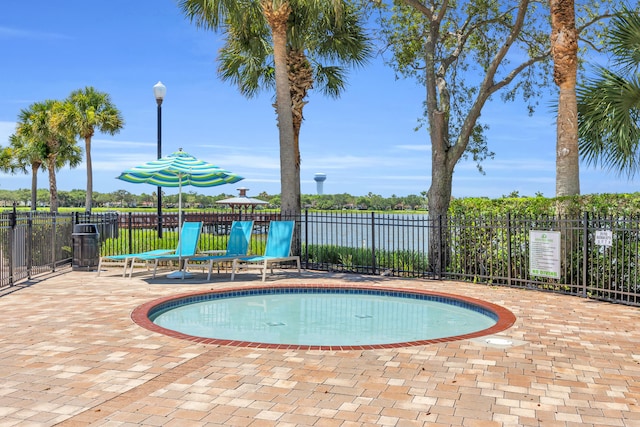 1909 Flower Dr, Palm Beach Gardens, FL 33410 - view of pool featuring a swimming pool, a patio, and a water view