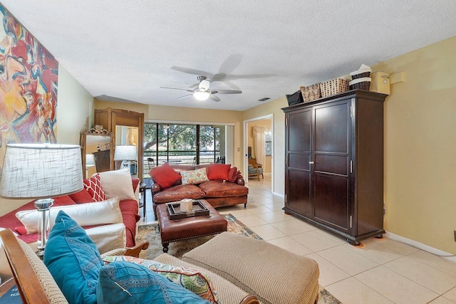 2890 SW 22nd Cir Unit 242B, Delray Beach, FL 33445 - living area featuring ceiling fan, baseboards, light tile patterned floors, and a textured ceiling