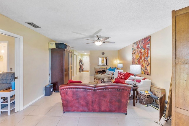2890 SW 22nd Cir Unit 242B, Delray Beach, FL 33445 - living room featuring ceiling fan, light tile patterned floors, a textured ceiling, and baseboards