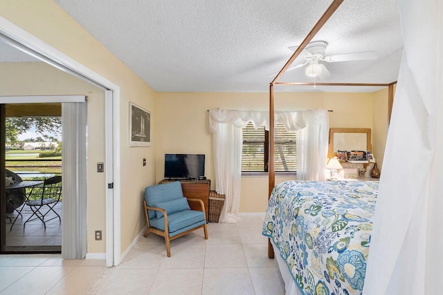 2890 SW 22nd Cir Unit 242B, Delray Beach, FL 33445 - bedroom with access to exterior, a textured ceiling, tile patterned flooring, baseboards, and ceiling fan
