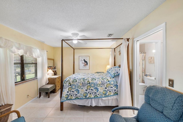 2890 SW 22nd Cir Unit 242B, Delray Beach, FL 33445 - bedroom featuring tile patterned floors, ensuite bath, a textured ceiling, and ceiling fan