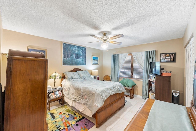 2890 SW 22nd Cir Unit 242B, Delray Beach, FL 33445 - bedroom featuring light tile patterned floors, a ceiling fan, and a textured ceiling