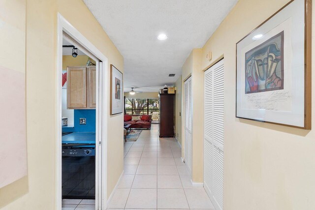 2890 SW 22nd Cir Unit 242B, Delray Beach, FL 33445 - hall featuring light tile patterned floors, recessed lighting, and baseboards