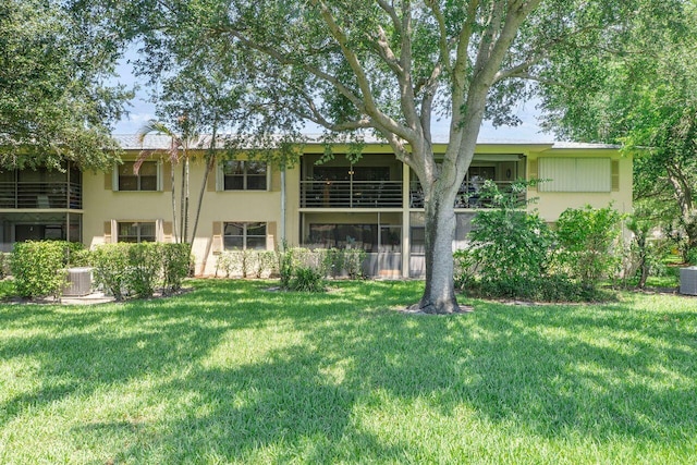 2890 SW 22nd Cir Unit 242B, Delray Beach, FL 33445 - back of house with a lawn, stucco siding, and central AC