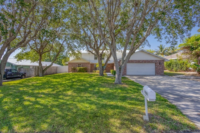 8888 SE Colony St, Hobe Sound, FL 33455 - view of front of house with brick siding, concrete driveway, and a garage