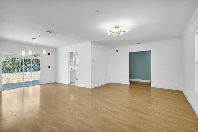 8888 SE Colony St, Hobe Sound, FL 33455 - spare room featuring a chandelier, light wood-type flooring, crown molding, baseboards, and fire sprinkler in ceiling