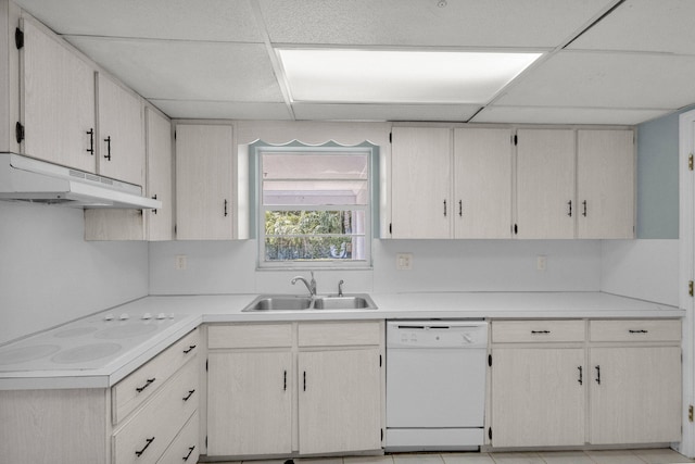 8888 SE Colony St, Hobe Sound, FL 33455 - kitchen featuring white appliances, under cabinet range hood, a sink, light countertops, and a paneled ceiling
