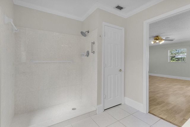 8888 SE Colony St, Hobe Sound, FL 33455 - bathroom with tiled shower, crown molding, tile patterned floors, and ceiling fan