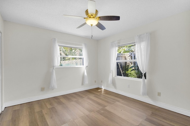 8888 SE Colony St, Hobe Sound, FL 33455 - unfurnished room with wood finished floors, baseboards, a ceiling fan, and a textured ceiling