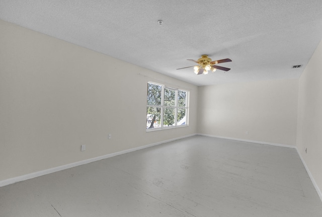 8888 SE Colony St, Hobe Sound, FL 33455 - unfurnished room with ceiling fan, concrete floors, baseboards, and a textured ceiling