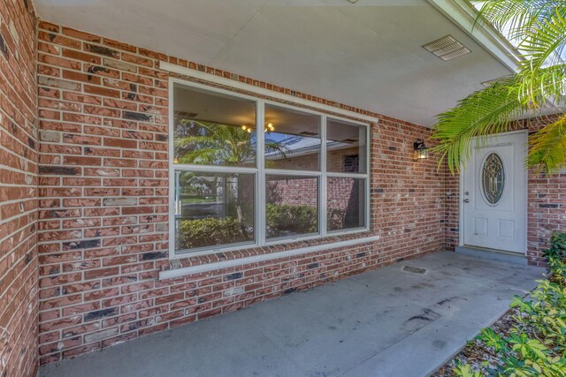 8888 SE Colony St, Hobe Sound, FL 33455 - view of exterior entry featuring brick siding