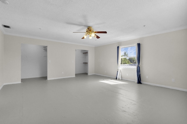8888 SE Colony St, Hobe Sound, FL 33455 - spare room with ornamental molding, ceiling fan, finished concrete flooring, a textured ceiling, and baseboards