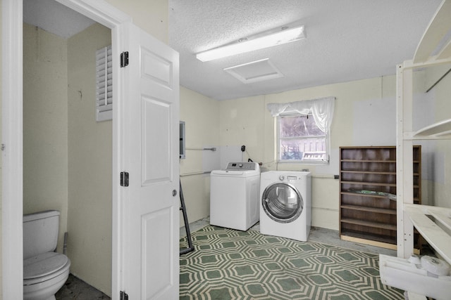 8888 SE Colony St, Hobe Sound, FL 33455 - laundry room with independent washer and dryer, attic access, and a textured ceiling