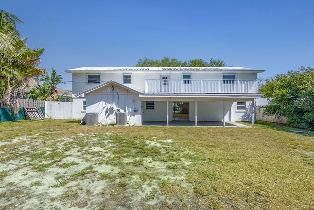 8888 SE Colony St, Hobe Sound, FL 33455 - back of property featuring central AC and a patio area