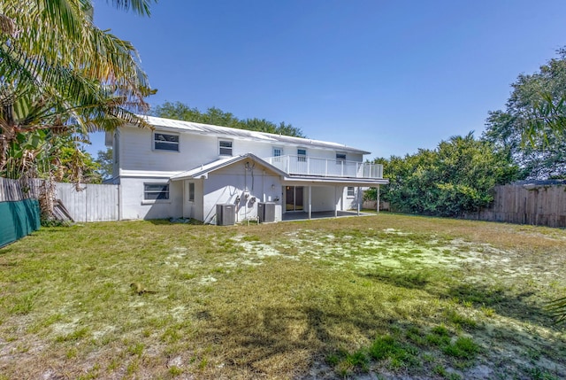 8888 SE Colony St, Hobe Sound, FL 33455 - back of property with central air condition unit and a patio