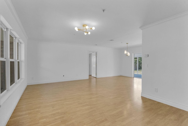 8888 SE Colony St, Hobe Sound, FL 33455 - spare room featuring a chandelier, light wood-style floors, ornamental molding, baseboards, and a pendent fire sprinkler