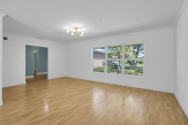 8888 SE Colony St, Hobe Sound, FL 33455 - spare room featuring light wood finished floors, a chandelier, ornamental molding, and baseboards