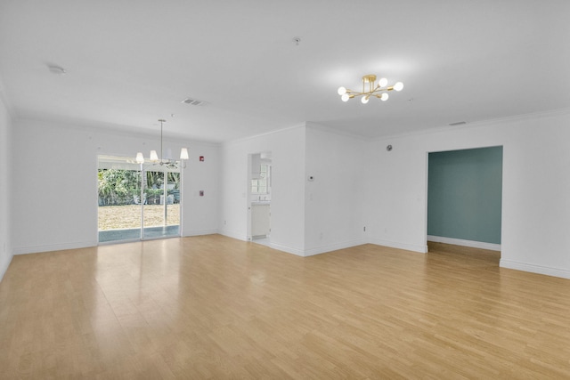 8888 SE Colony St, Hobe Sound, FL 33455 - spare room with a chandelier, light wood-style floors, baseboards, and ornamental molding