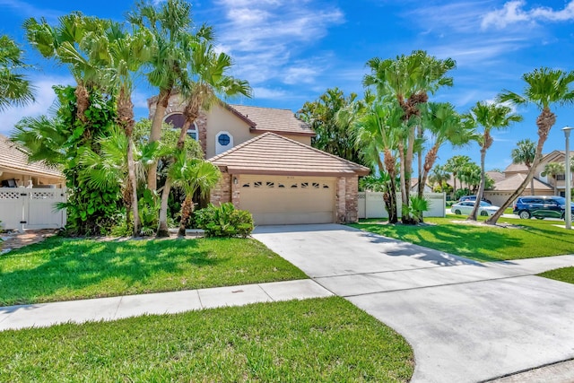 view of front of house featuring an attached garage, concrete driveway, a gate, a tiled roof, and stucco siding