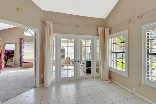 doorway to outside featuring vaulted ceiling, plenty of natural light, french doors, carpet, and baseboards