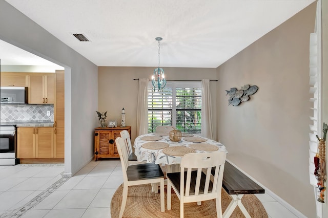 dining room featuring a chandelier and light tile patterned floors