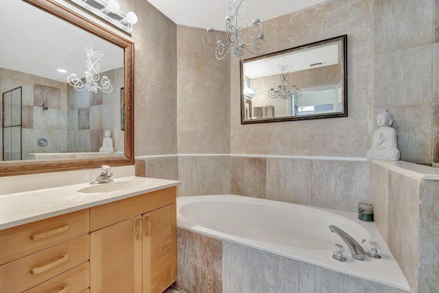full bathroom featuring a chandelier, a garden tub, vanity, and tiled shower