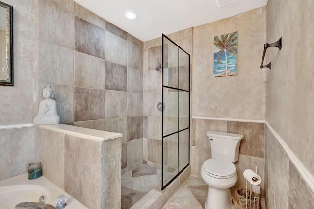 full bathroom featuring tile walls, toilet, walk in shower, a bath, and tile patterned flooring