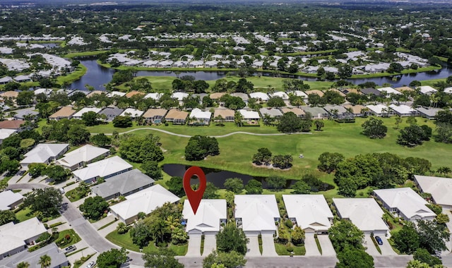 aerial view of property's location featuring nearby suburban area, a large body of water, and a local golf course
