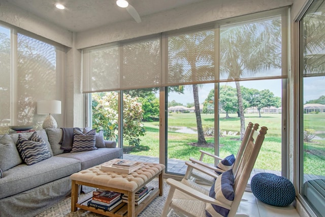 sunroom / solarium with outdoor lounge area, healthy amount of natural light, and view of golf course