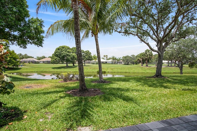 view of grassy yard with a water view