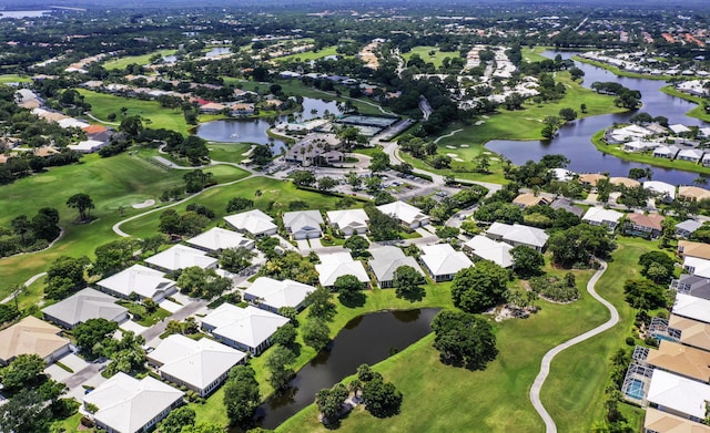 view of property location featuring nearby suburban area, a nearby body of water, and a golf club