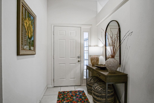 entrance foyer featuring light tile patterned floors and baseboards