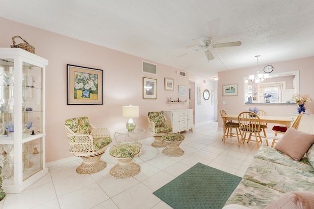2151 NE 1st Ct Unit 102, Boynton Beach, FL 33435 - living room featuring a ceiling fan, light tile patterned floors, and a chandelier