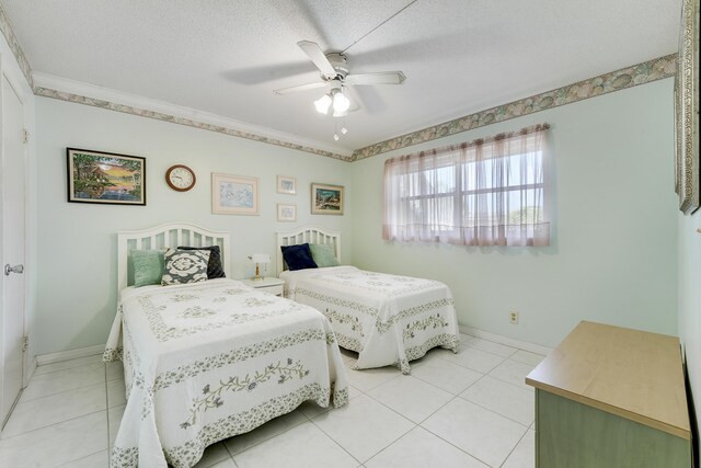 2151 NE 1st Ct Unit 102, Boynton Beach, FL 33435 - bedroom featuring light tile patterned flooring, a ceiling fan, baseboards, a textured ceiling, and ornamental molding
