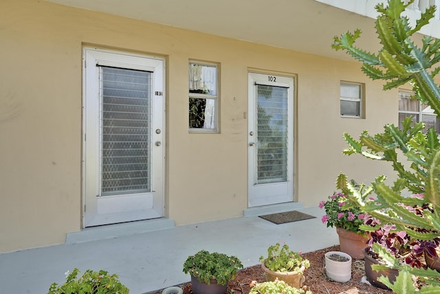 2151 NE 1st Ct Unit 102, Boynton Beach, FL 33435 - doorway to property with stucco siding