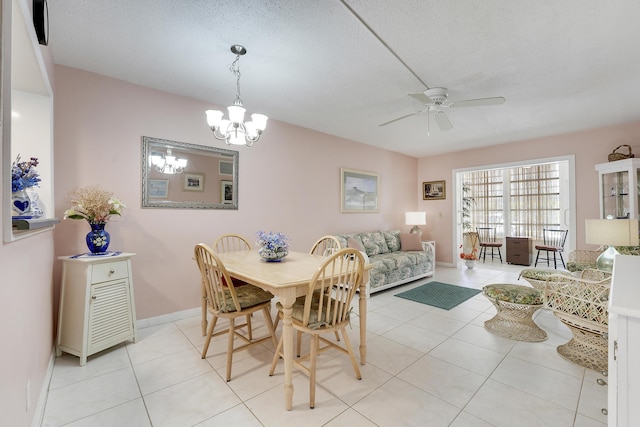 2151 NE 1st Ct Unit 102, Boynton Beach, FL 33435 - dining room featuring ceiling fan, a chandelier, light tile patterned floors, baseboards, and a textured ceiling