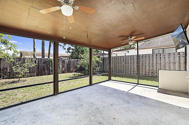 unfurnished sunroom featuring ceiling fan