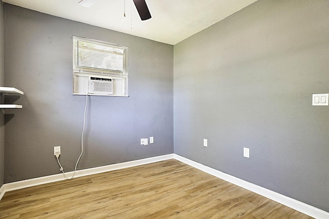 unfurnished room with ceiling fan, baseboards, wood finished floors, and cooling unit