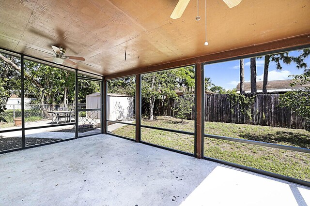unfurnished sunroom with a ceiling fan