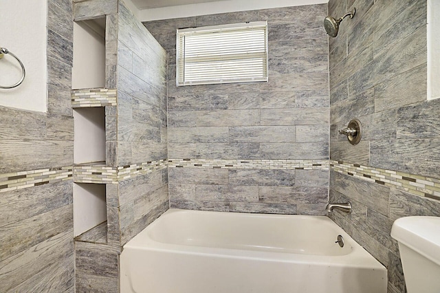 full bath with tile walls, toilet, and tub / shower combination