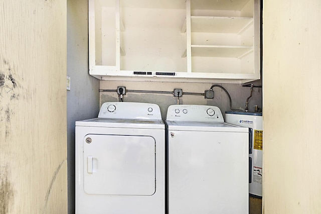 laundry room featuring water heater and independent washer and dryer